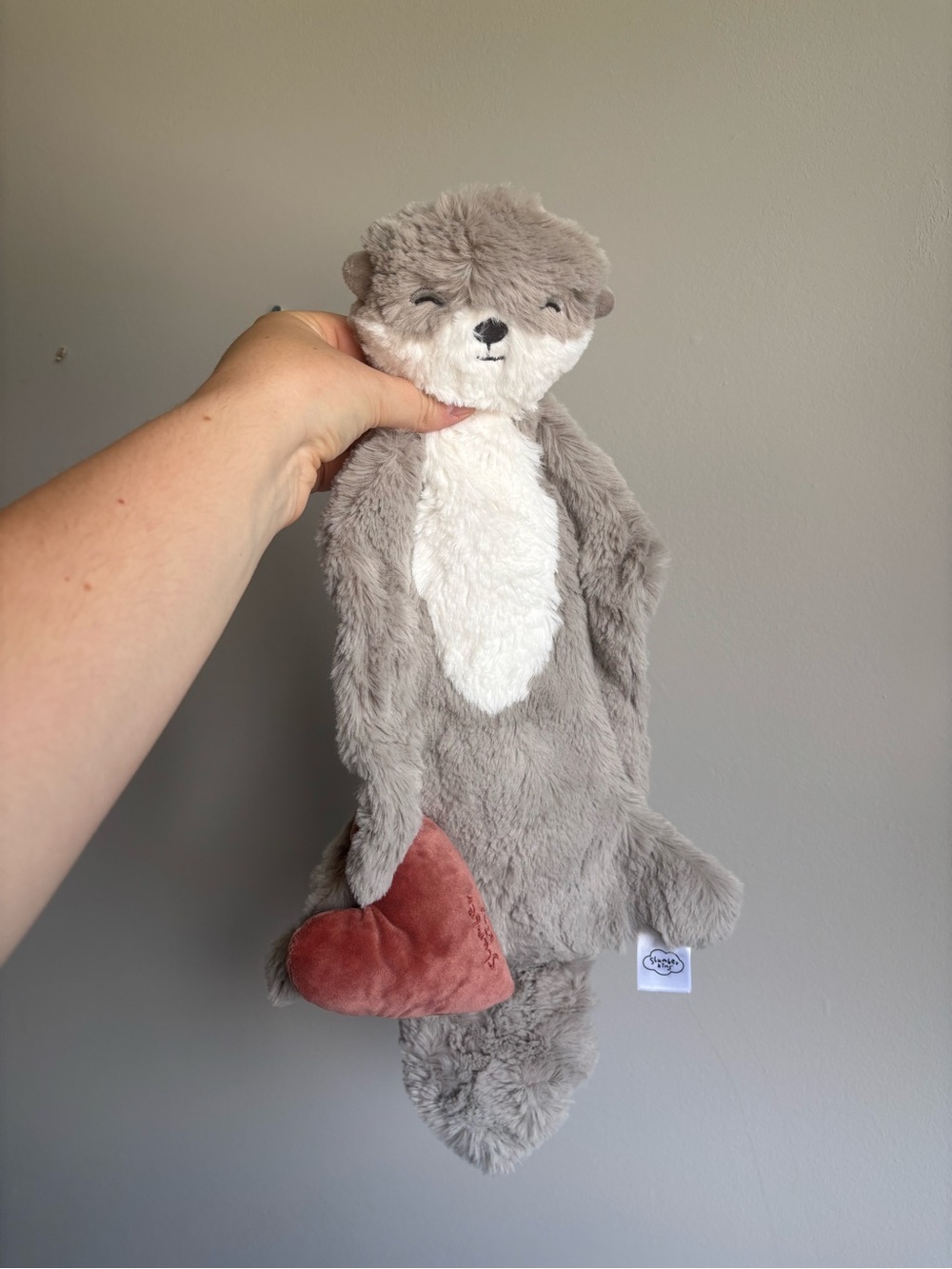 Slumberkins otter plush with a heart
